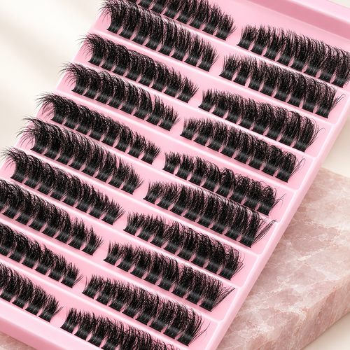 3D cluster false lashes, ten rows on a pink tray, on pale rose stone