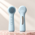 Silicone facial cleansing brush, front and back view, on pale rose stone