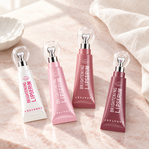 Brightening lip serum tubes on a marble vanity with a ceramic dish and linen