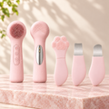 Face Cleansing Duo: the pink silicone cleansing brush, front and back, next to the pink cat paw tool shown closed and opened